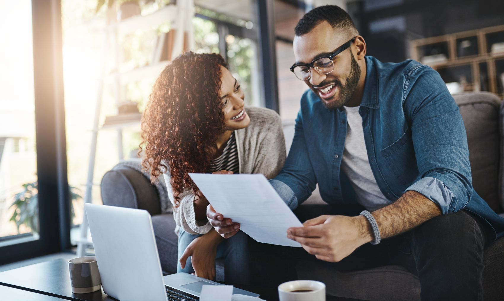 A couple reviewing financial paperwork at home