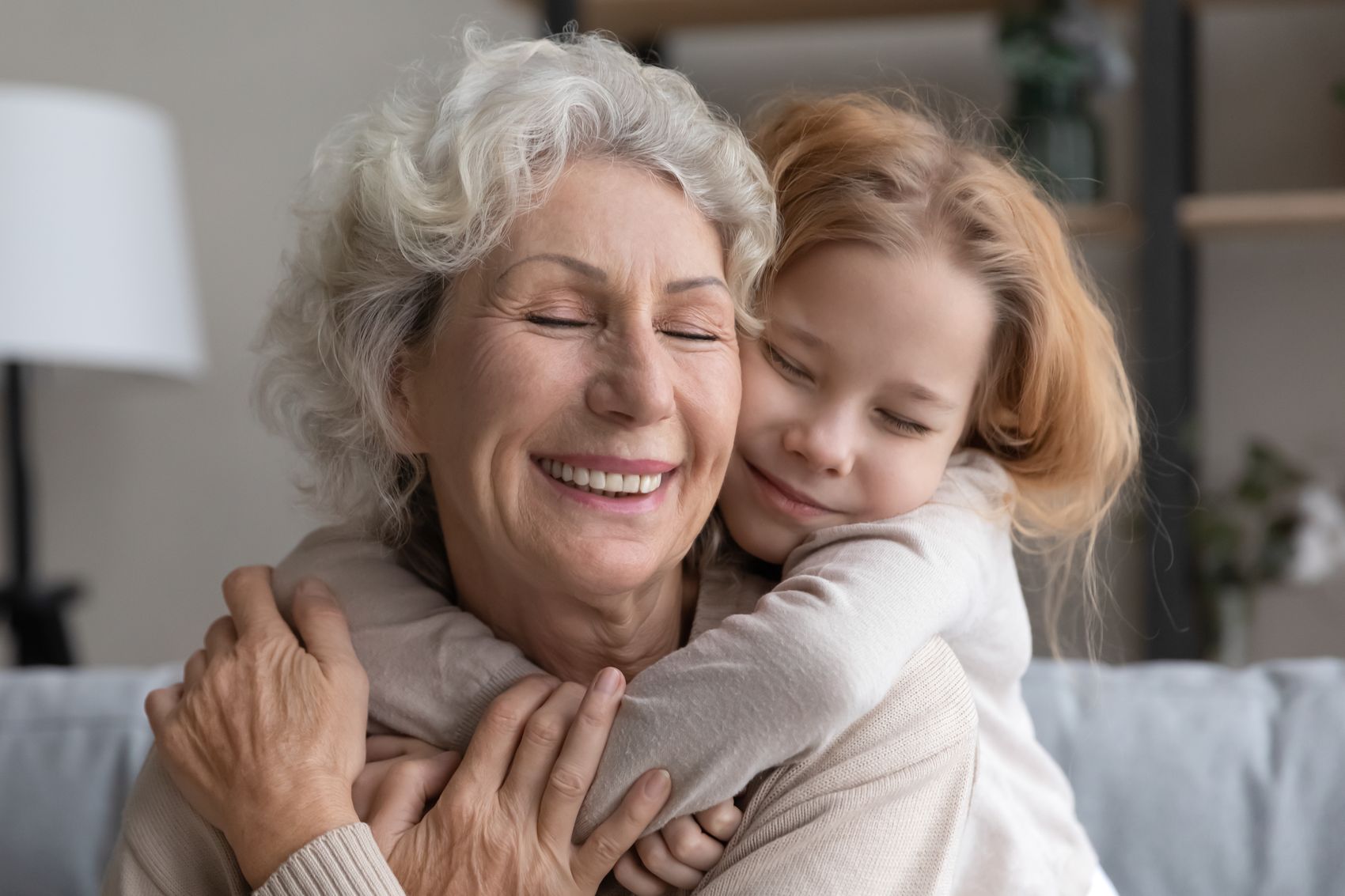 A grandmother embracing her granddaughter